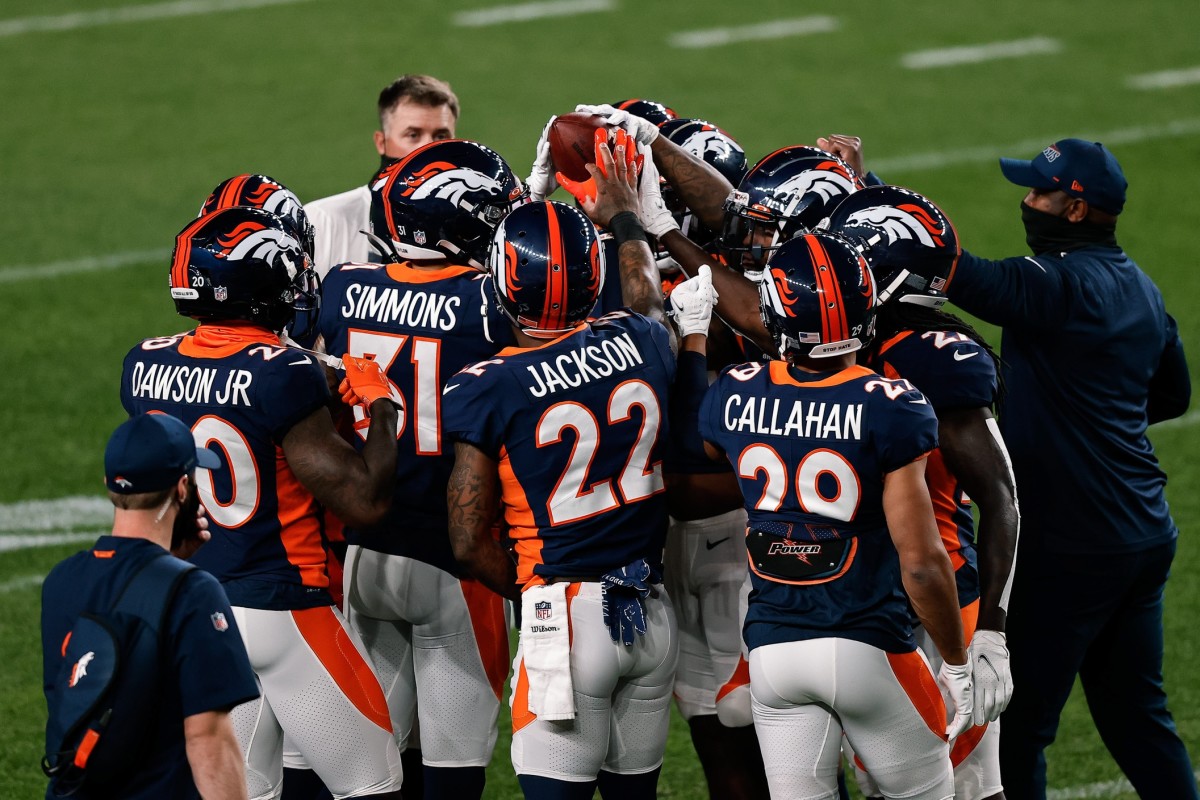 Denver Broncos cornerback Duke Dawson Jr. (20) and free safety Justin Simmons (31) and strong safety Kareem Jackson (22) and cornerback Bryce Callahan (29) with teammates before the game against the Tennessee Titans at Coors Field.