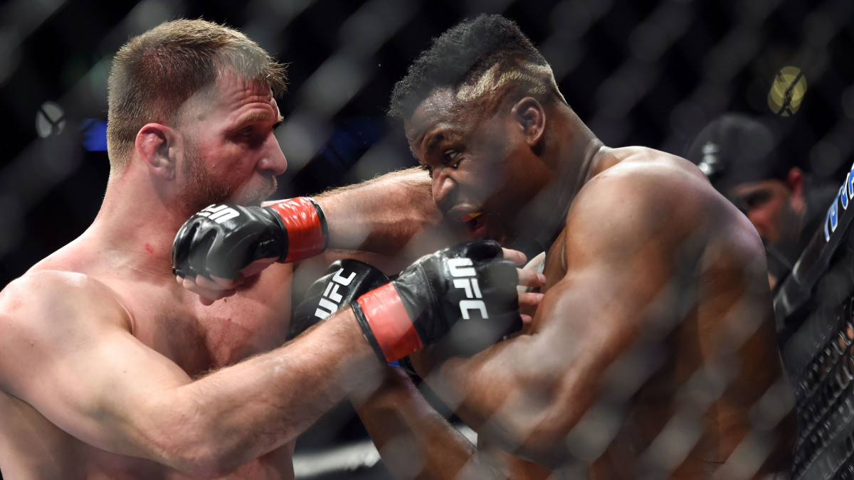 Stipe Miocic (red gloves) fights Francis Ngannou (blue gloves) during UFC 220 at the TD Garden.