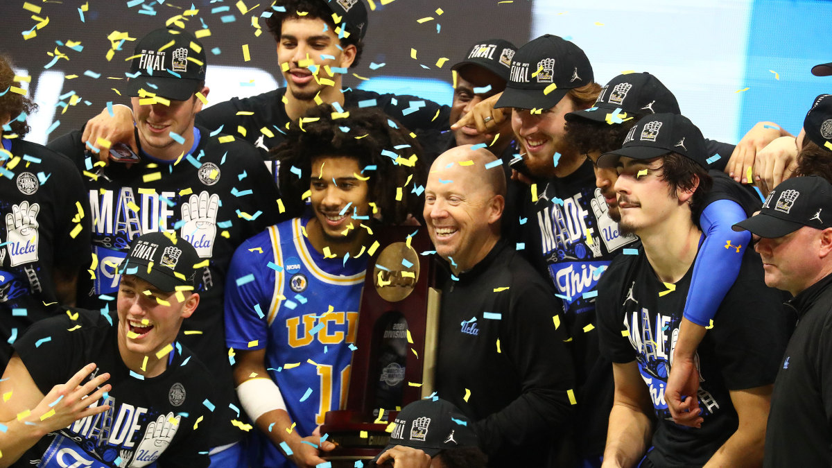 UCLA's Mick Cronin celebrates with his team after beating Michigan