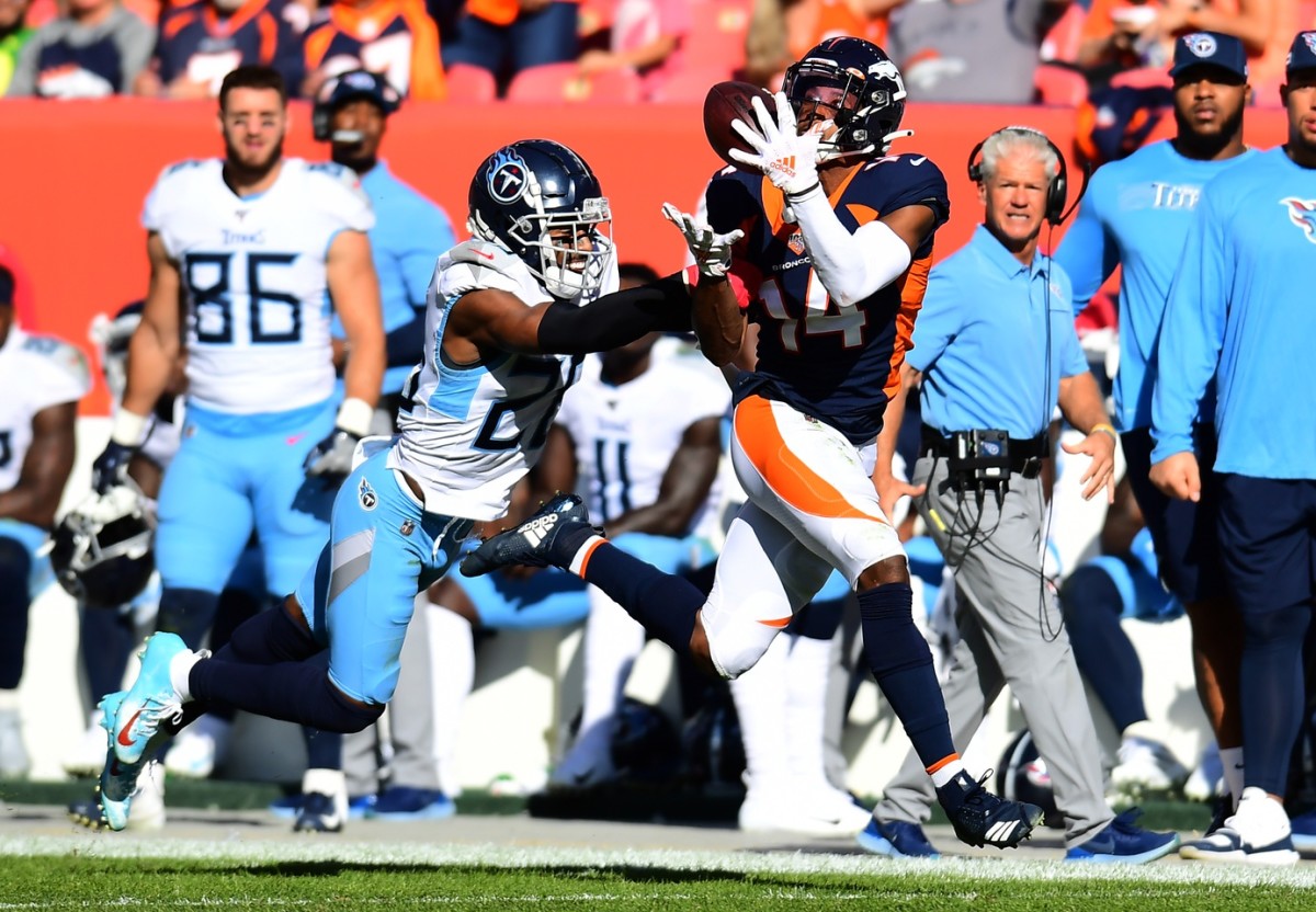 Denver Broncos wide receiver Courtland Sutton (14) catches a pass against Tennessee Titans cornerback Logan Ryan (26) in the second quarter at Empower Field at Mile High.