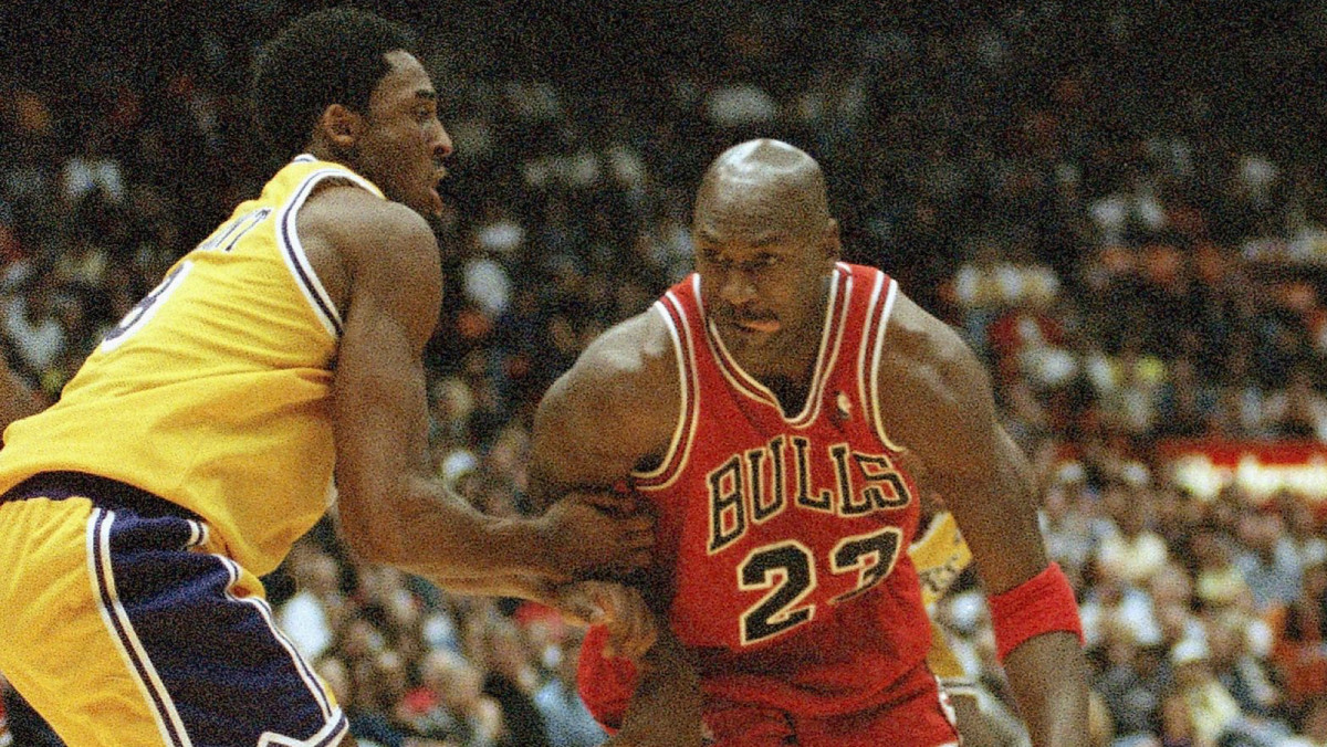 Michael Jordan is held up by Los Angeles Lakers Kobe Bryant in 1998.