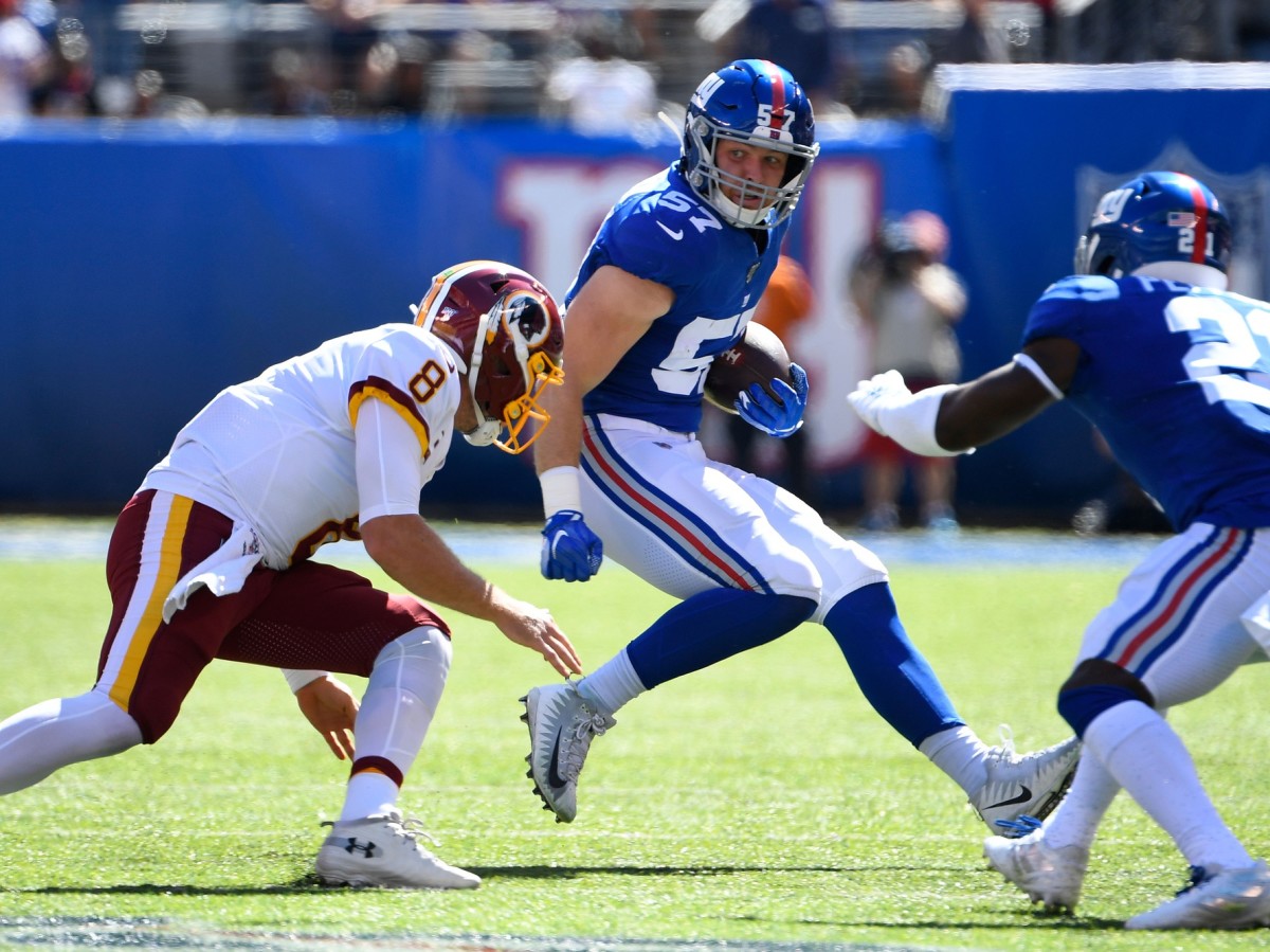 Sep 29, 2019; East Rutherford, NJ, USA; New York Giants inside linebacker Ryan Connelly (57) runs with the ball after intercepting a pass from Washington Redskins quarterback Case Keenum (not pictured) in the first quarter at MetLife Stadium.