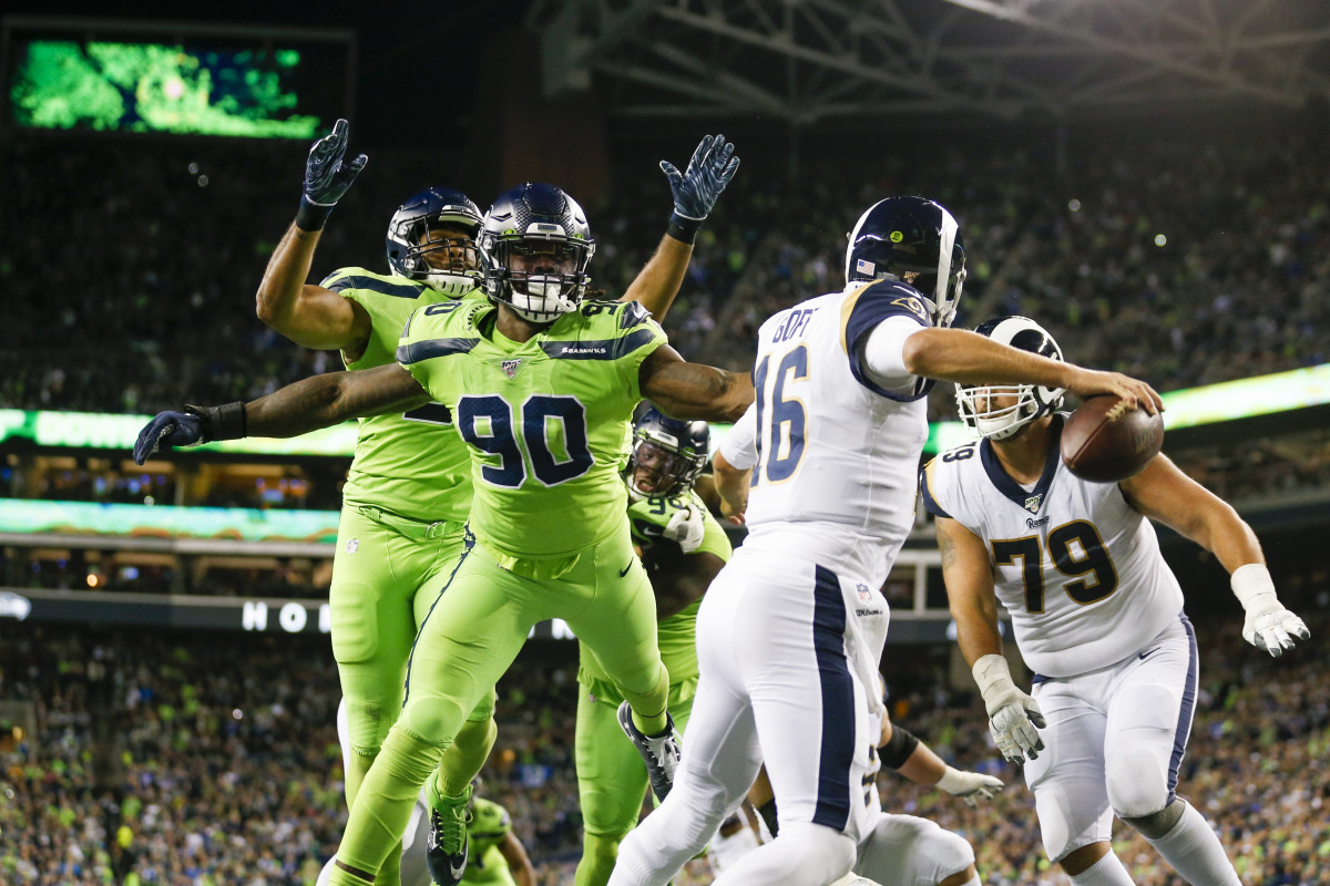 Seattle Seahawks outside linebacker Jadeveon Clowney (90) and outside linebacker K.J. Wright (50) pressure Los Angeles Rams quarterback Jared Goff (16) during the third quarter at CenturyLink Field.