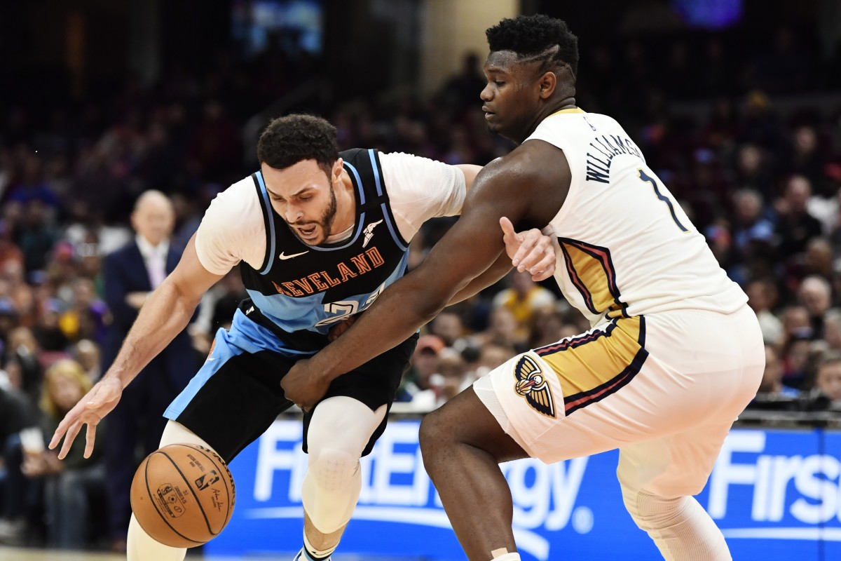 Cavaliers power forward Larry Nance Jr. battles Pelicans rookie Zion Williamson for the ball.