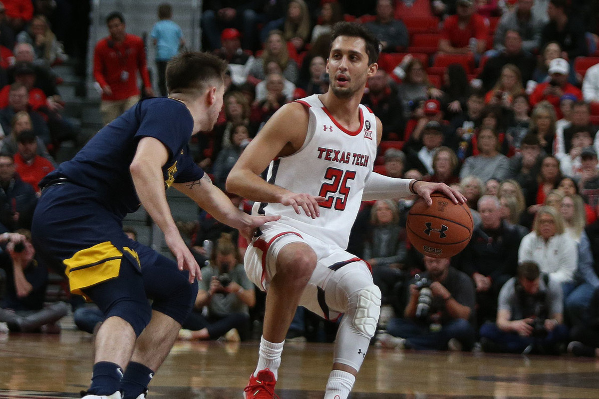Texas Tech Red Raiders guard Davide Moretti (25) looks for an opening against West Virginia Mountaineers Jordan MCabe (5) in the first half at United Supermarkets Arena.