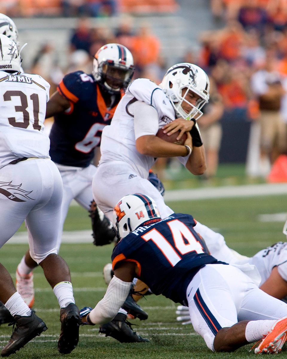 Illinois Fighting Illini defensive lineman Gimel President (14) sacks Western Michigan Broncos quarterback Zach Terrell (11) during the third quarter at Memorial Stadium. Western Michigan beat Illinois 34 to 10.