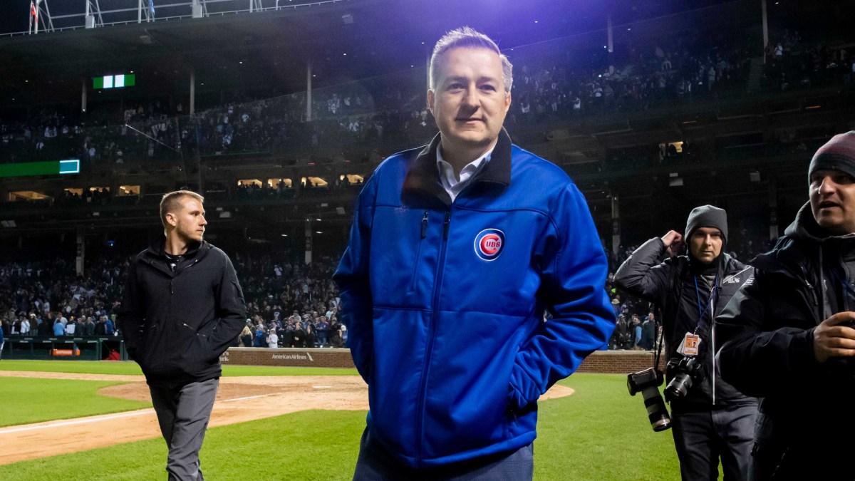 Cubs owner Tom Rickets walks on the grass at Wrigley Field