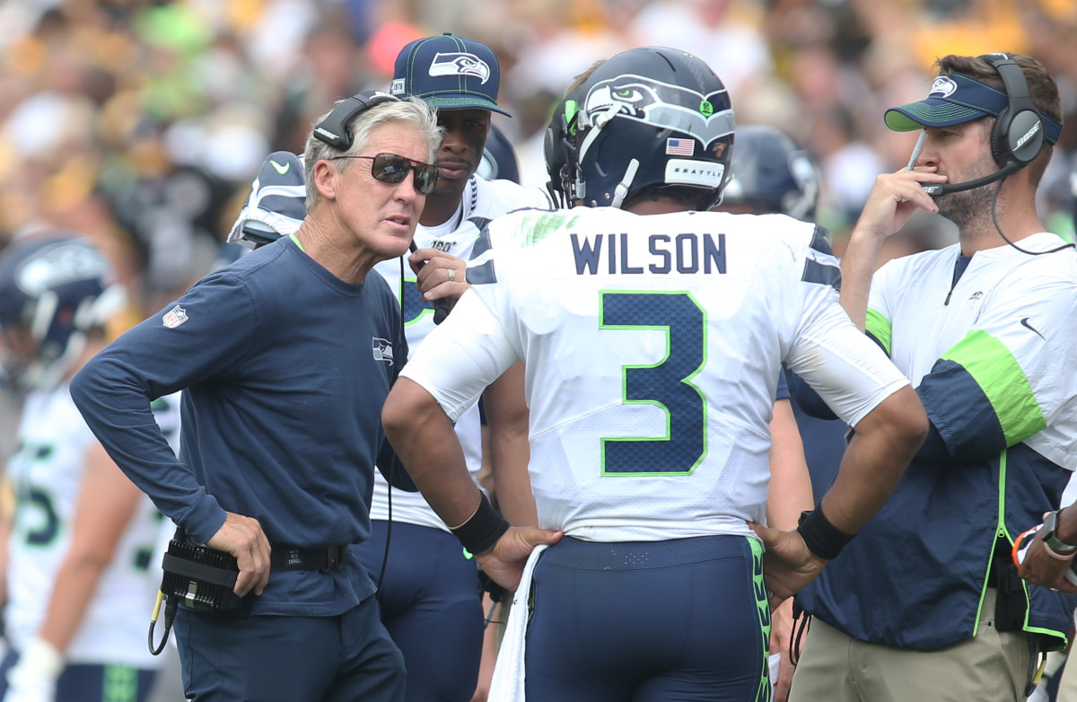 Seattle Seahawks head coach Pete Carroll (left) talks with quarterback Russell Wilson (3) on the sidelines during the second quarter against the Pittsburgh Steelers at Heinz Field.