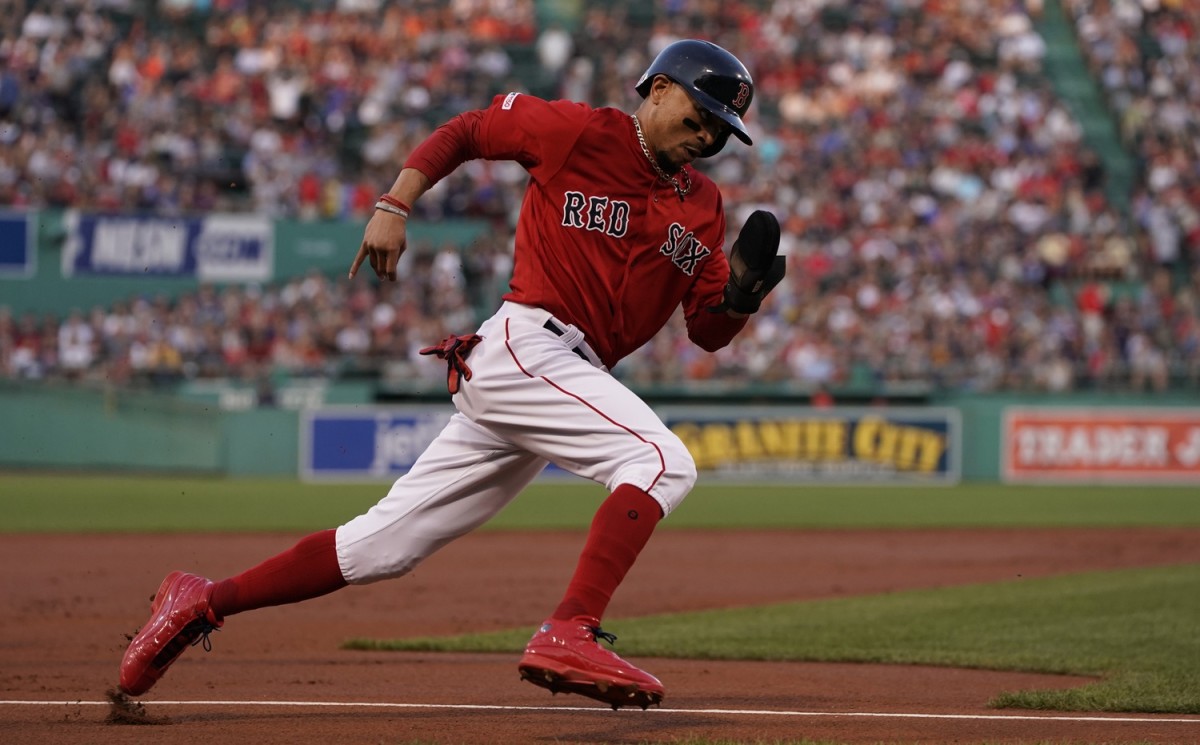 Aug 16, 2019; Boston, MA, USA; Boston Red Sox right fielder Mookie Betts (50) rounds third to score on a base hit by third baseman Rafael Devers (11) (not pictured) against the Baltimore Orioles in the first inning at Fenway Park. Mandatory Credit: David Butler II-USA TODAY Sports
