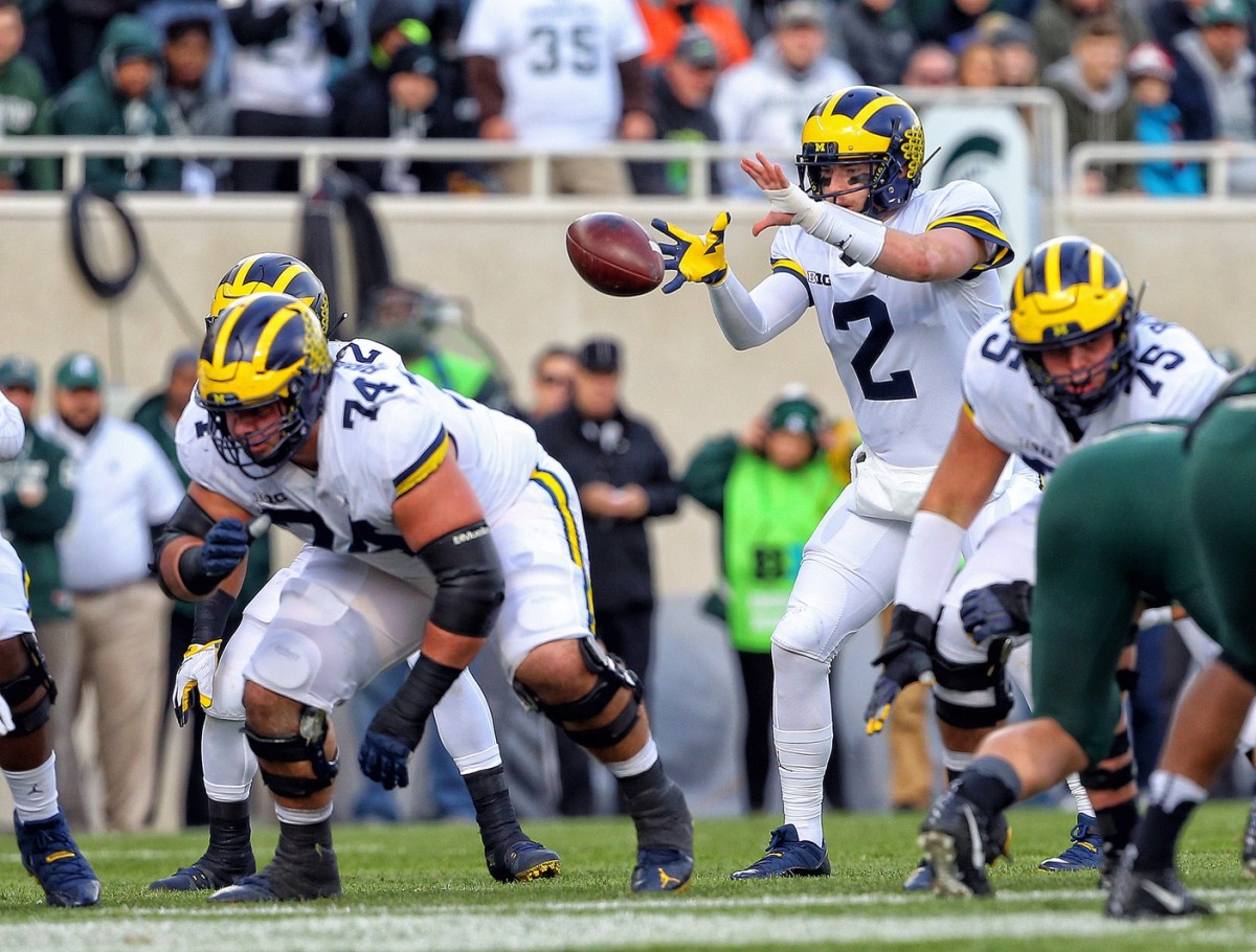 Oct 20, 2018; East Lansing, MI, USA; Michigan Wolverines quarterback Shea Patterson (2) takes the snap of the ball from Michigan Wolverines offensive lineman Cesar Ruiz (51)(not pictured) during the first quarter of a game at Spartan Stadium.