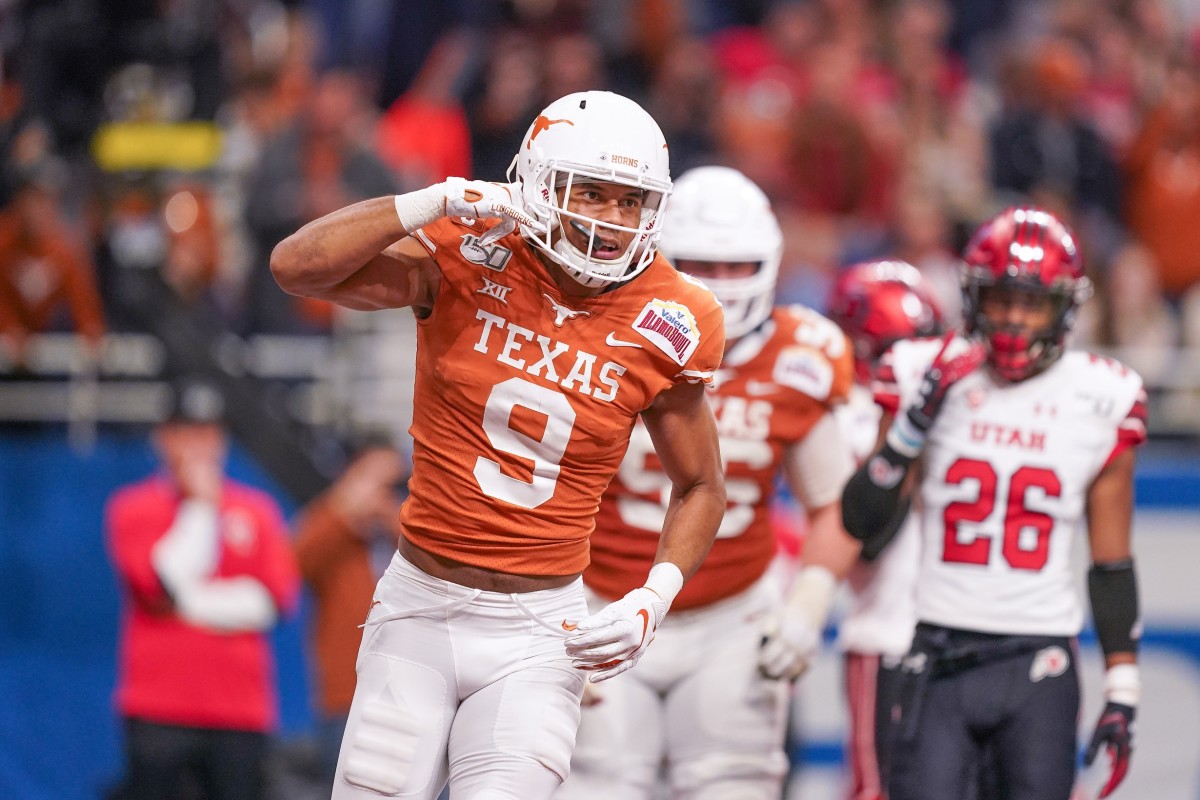 Dec 31, 2019; San Antonio, Texas, USA; Texas Longhorns wide receiver Collin Johnson (9) celebrates a touchdown catch against the Utah Utes during the first half at the Alamodome.