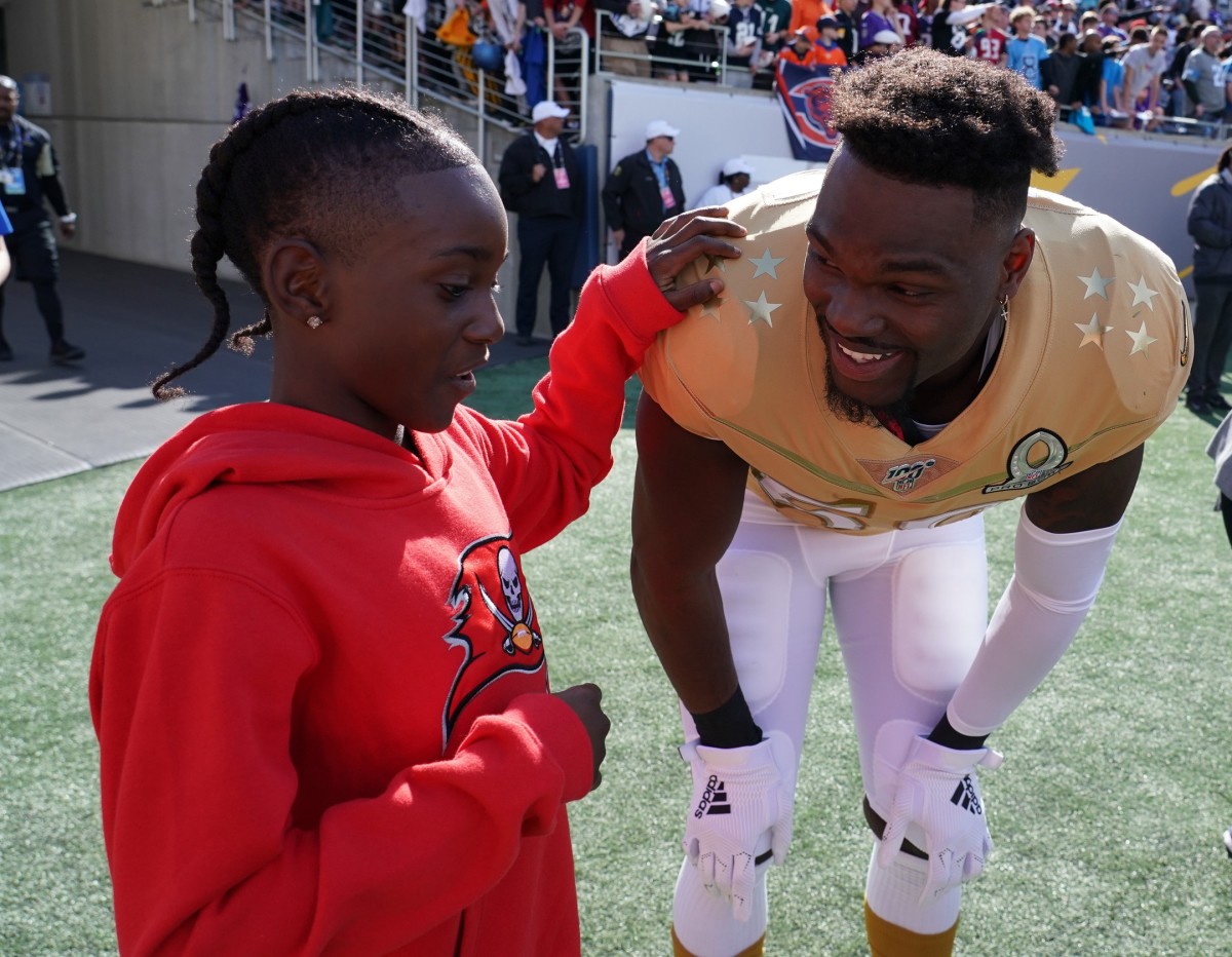 NFC linebacker Shaquil Barrett of the Tampa Bay Buccaneers (58) interacts with a youngster during the 2020 NFL Pro Bowl at Camping World Stadium.