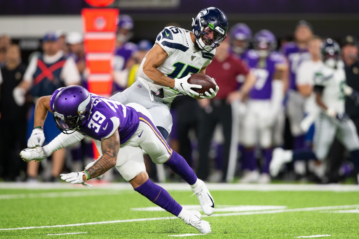 Seattle Seahawks wide receiver John Ursua (15) avoids a tackle by Minnesota Vikings safety Marcus Epps (39) at U.S. Bank Stadium.