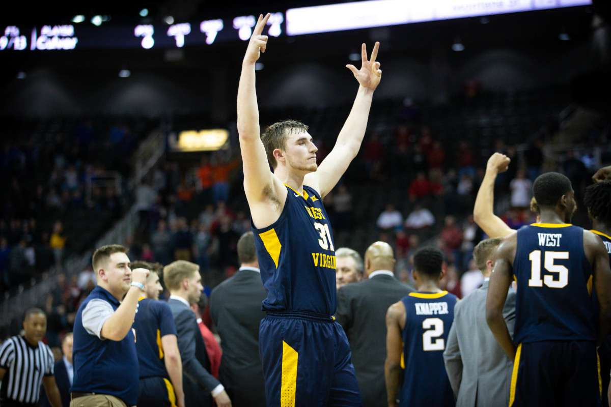 West Virginia Mountaineers forward Logan Routt (31) celebrates after the game against the Oklahoma Sooners in the first round of the Big 12 conference tournament at Sprint Center.