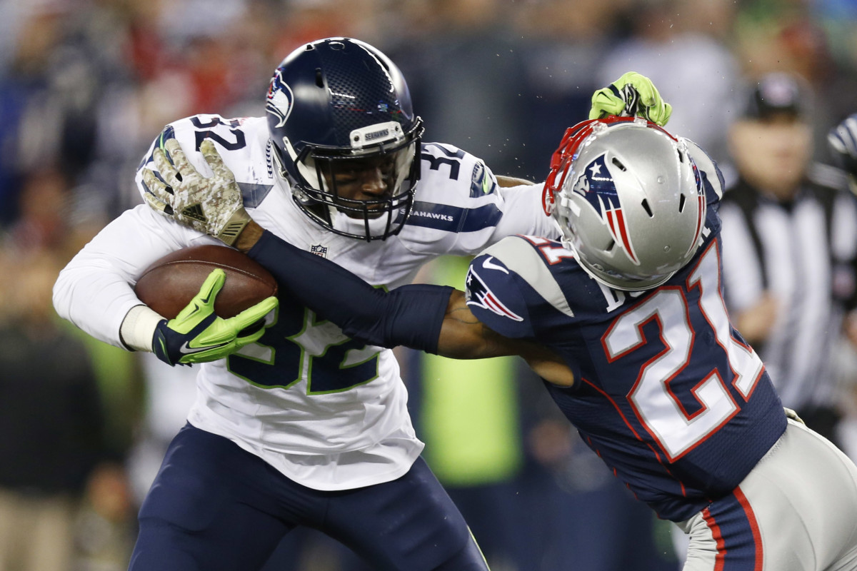 Seattle Seahawks running back Christine Michael (32) is tackled by New England Patriots cornerback Malcolm Butler (21) during the fourth quarter at Gillette Stadium. The Seattle Seahawks won 31-24.