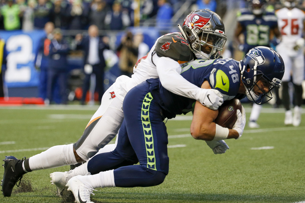 Seattle Seahawks tight end Jacob Hollister (48) dives for the end zone to score a touchdown before being tackled by Tampa Bay Buccaneers free safety Jordan Whitehead (31) during overtime at CenturyLink Field.