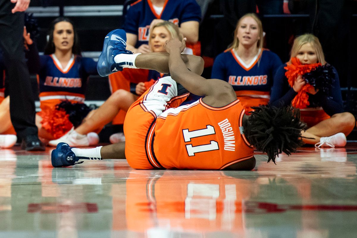 Illinois Fighting Illini guard Ayo Dosunmu (11) reacts after a last-second left leg injury against the Michigan State Spartans at State Farm Center.