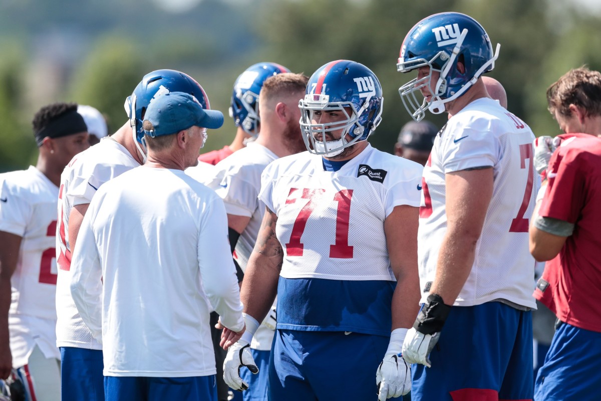Jul 25, 2019; East Rutherford, NJ, USA; New York Giants offensive guard Will Hernandez (71) and offensive tackle Nate Solder (76) talk with head coach Pat Shurmur during the first day of training camp at Quest Diagnostics Training Center.