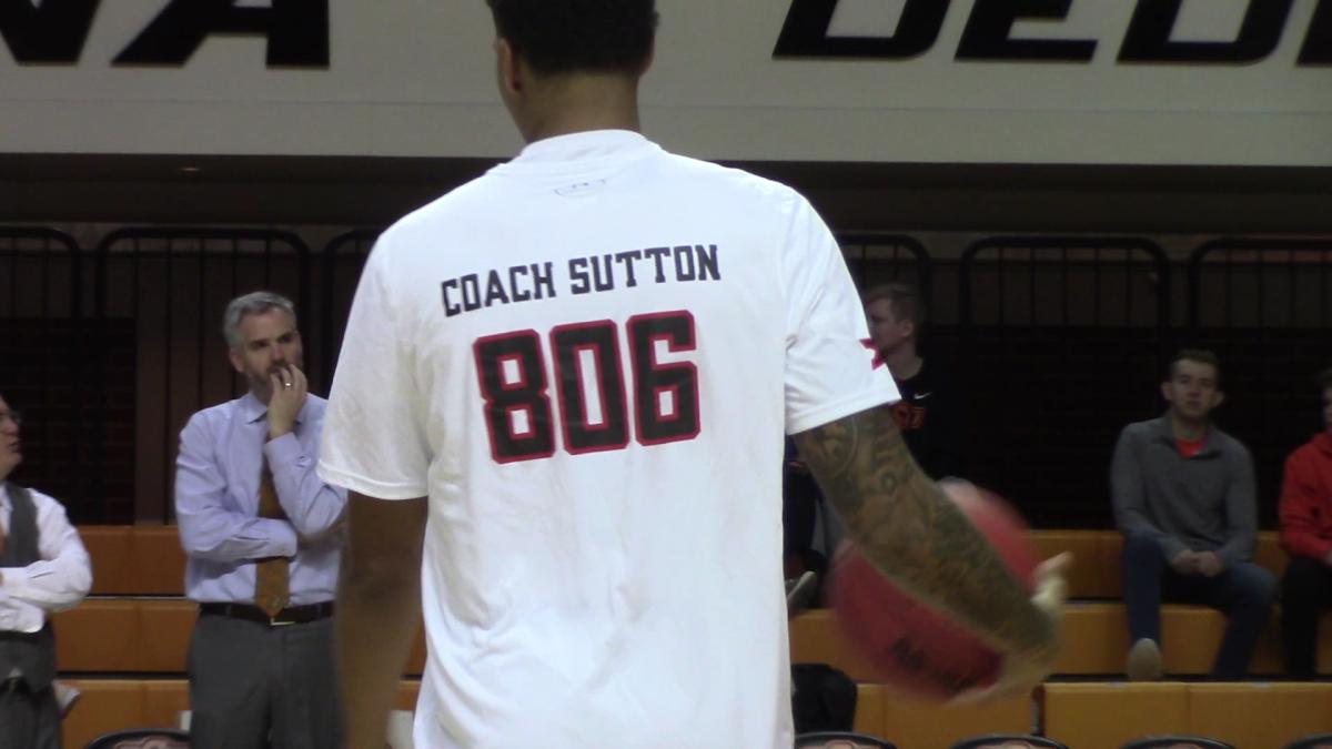 Cowboys assistant Scott Sutton in the background as a Texas Tech player warming up sports the shooting shirt honoring Eddie Sutton and a pitch for him to be voted into the Hall of Fame.