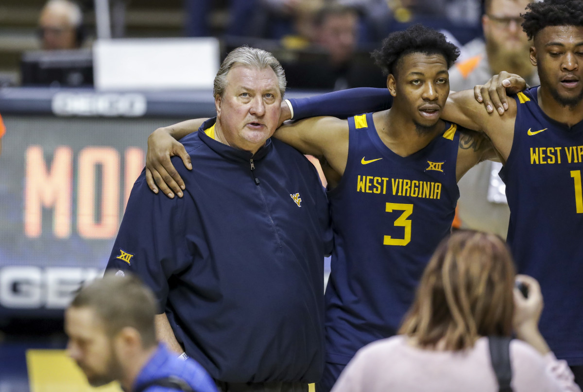 West Virginia Mountaineers head coach Bob Huggins sings \"Country Roads\" after his team defeated the Kansas State Wildcats at WVU Coliseum.