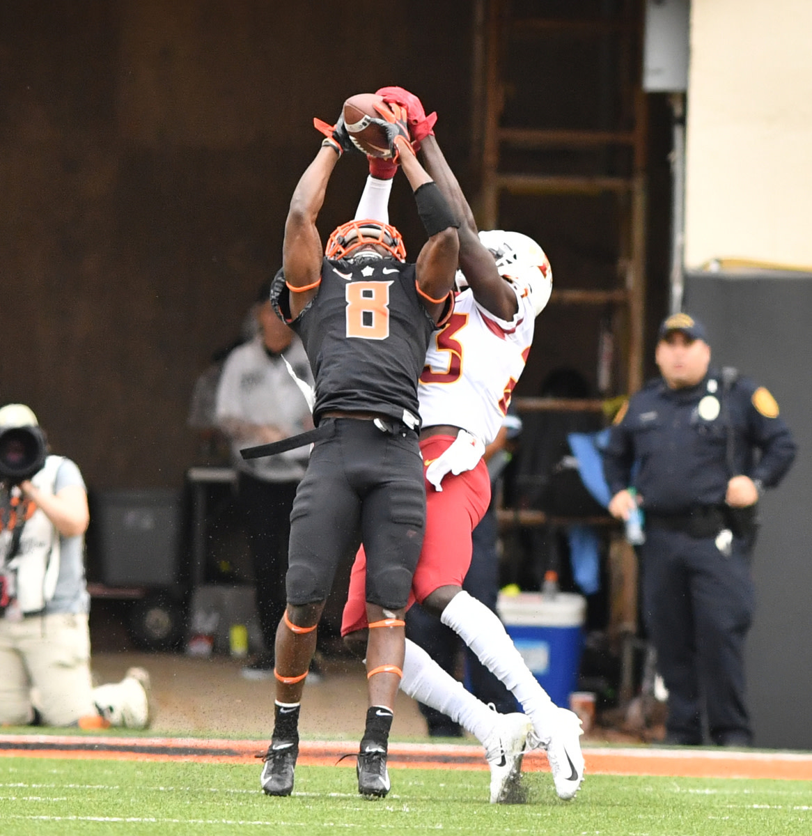 Rodarius Williams (#8) goes high to take away a pass from an Iowa State receiver.