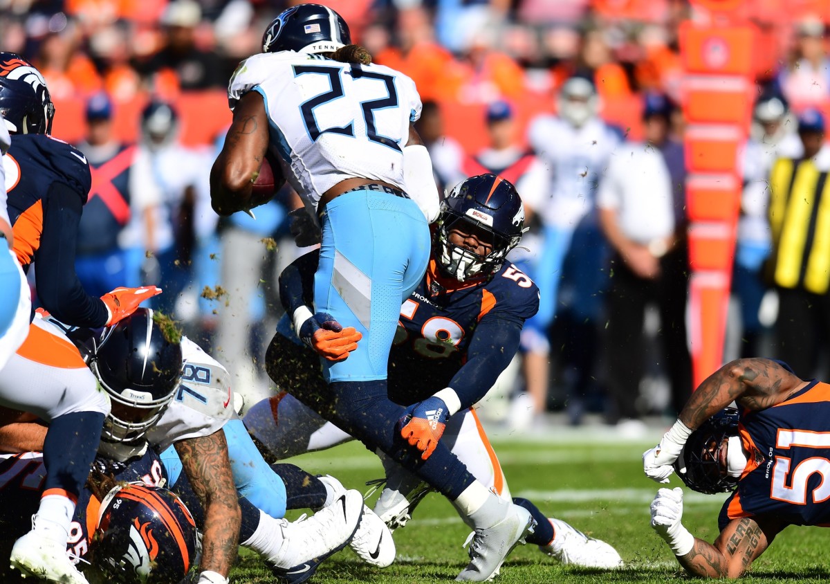 Denver Broncos linebacker Von Miller (58) tackles Tennessee Titans running back Derrick Henry (22) in the second quarter at Empower Field at Mile High.