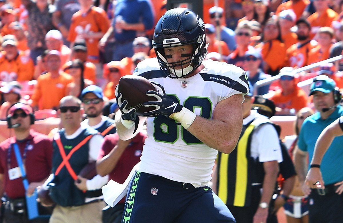 Seattle Seahawks tight end Will Dissly (88) pulls in a touchdown reception in the first quarter against the Denver Broncos at Broncos Stadium at Mile High.