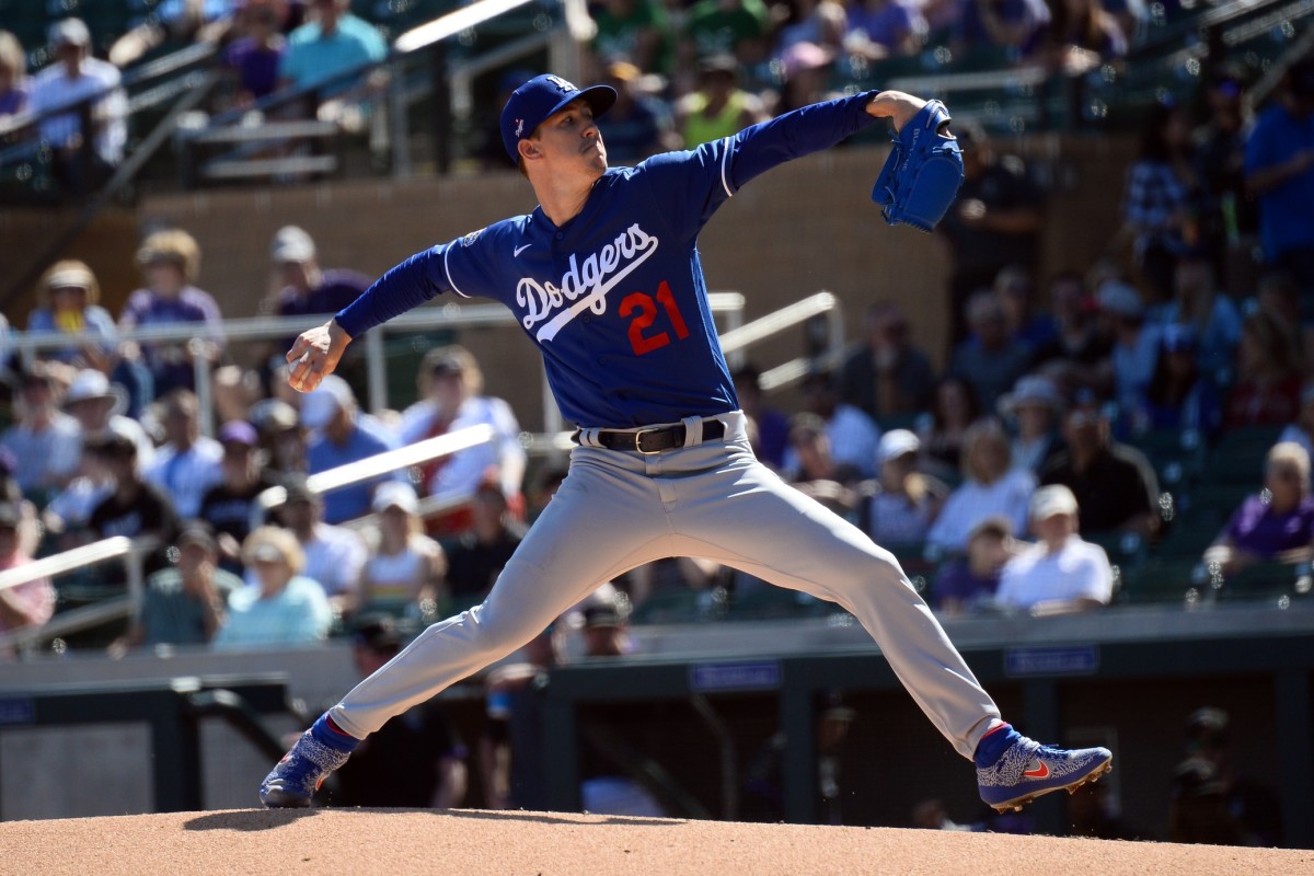 Feb 29, 2020; Salt River Pima-Maricopa, Arizona, USA; Los Angeles Dodgers starting pitcher Walker Buehler (21) throws against the Colorado Rockies during the first inning of a spring training game at Salt River Fields at Talking Stick. Mandatory Credit: Joe Camporeale-USA TODAY Sports