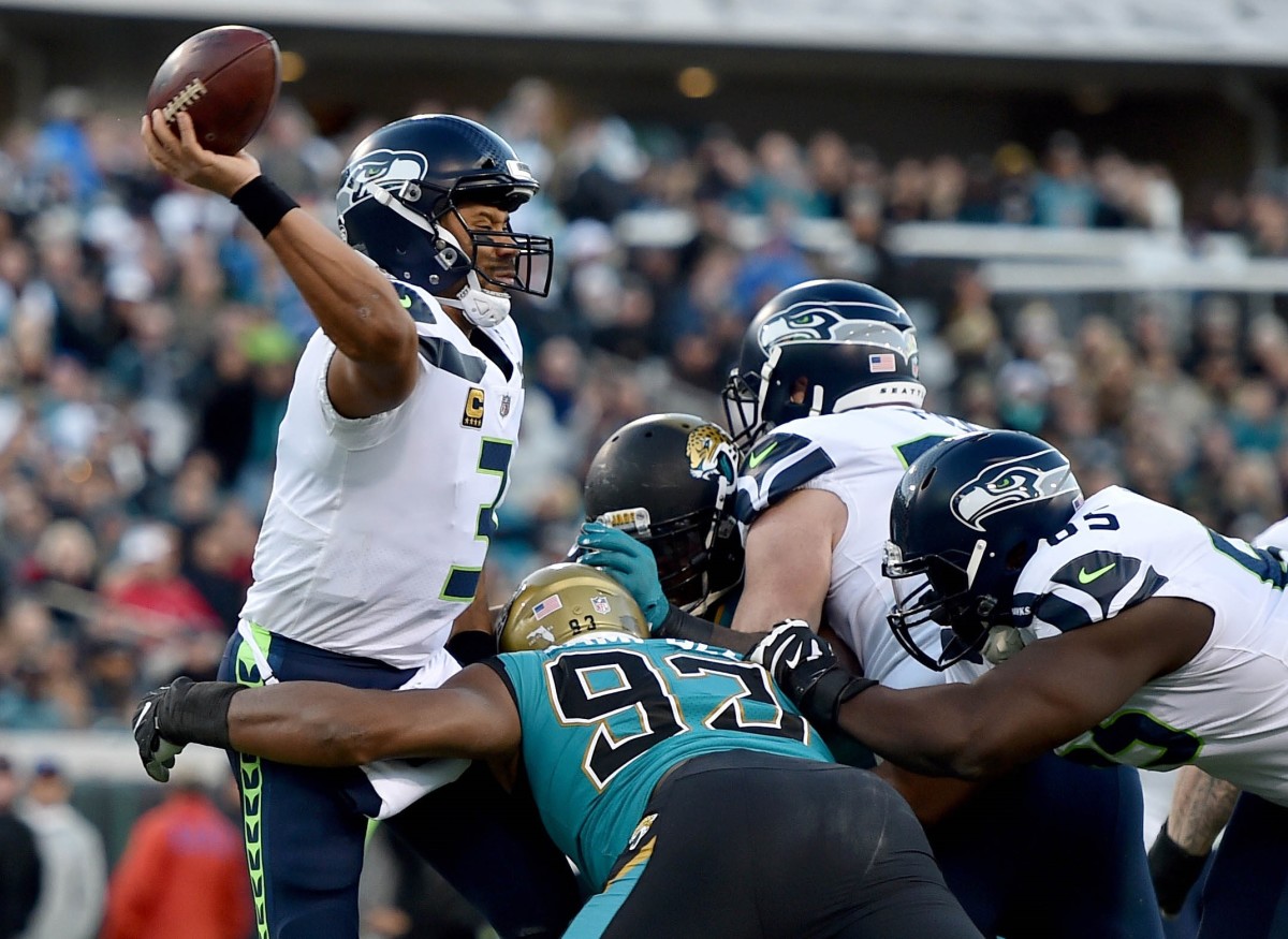 Seattle Seahawks quarterback Russell Wilson (3) is hit by Jacksonville Jaguars defensive end Calais Campbell (93) during the first half at EverBank Field.
