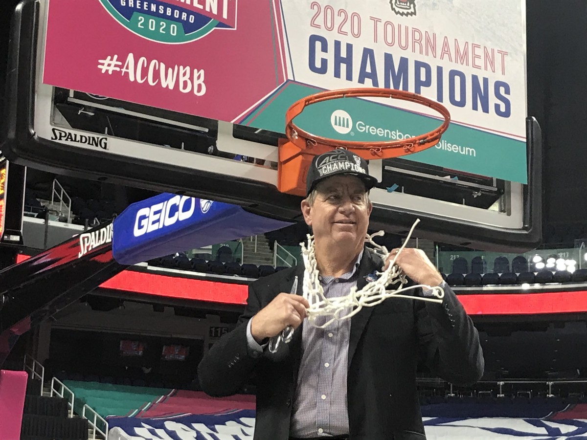 Moore is wet, but happy as he cuts down the nets at Greensboro Coliseum