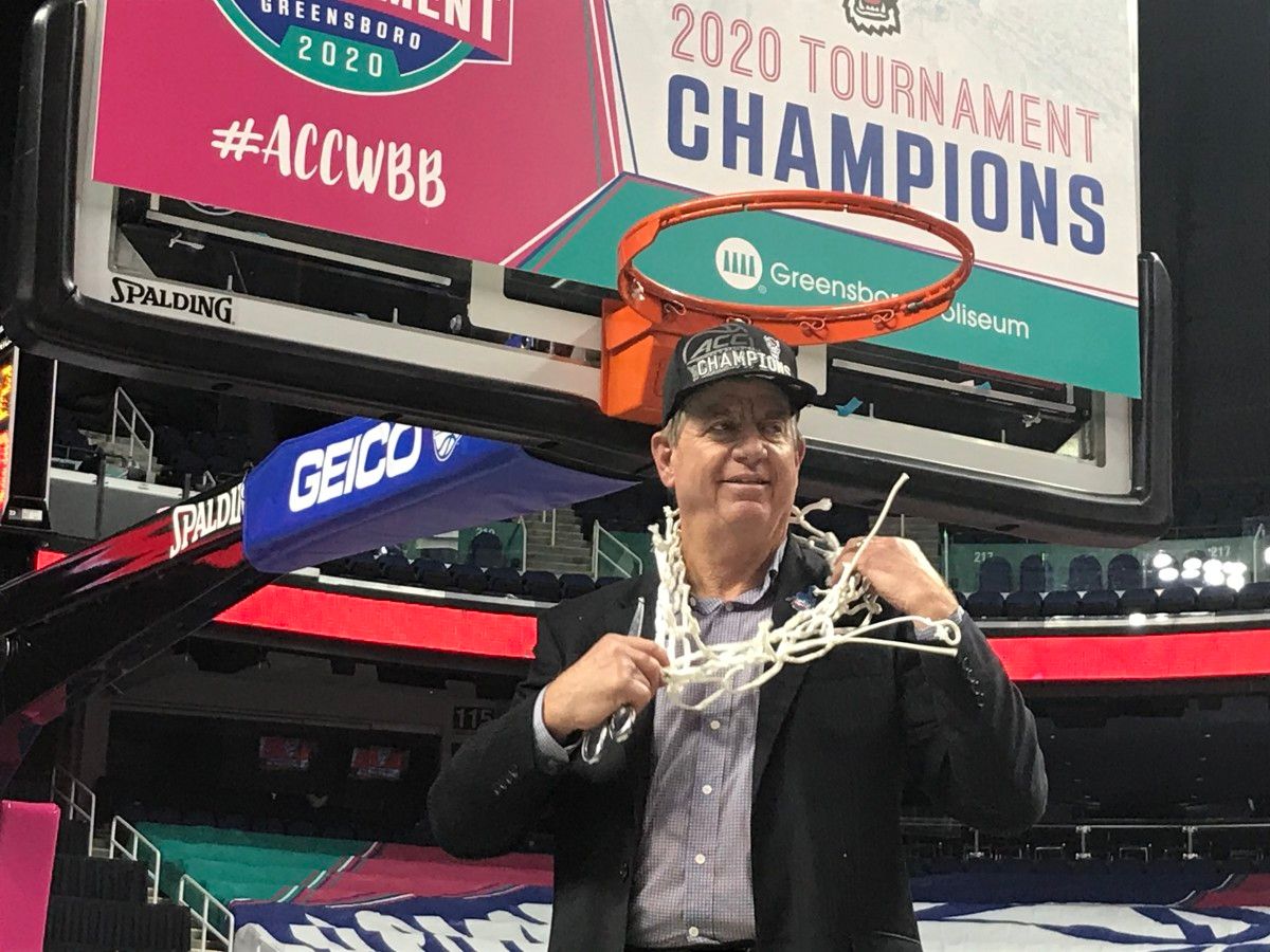 Moore is wet, but happy as he cuts down the nets at Greensboro Coliseum