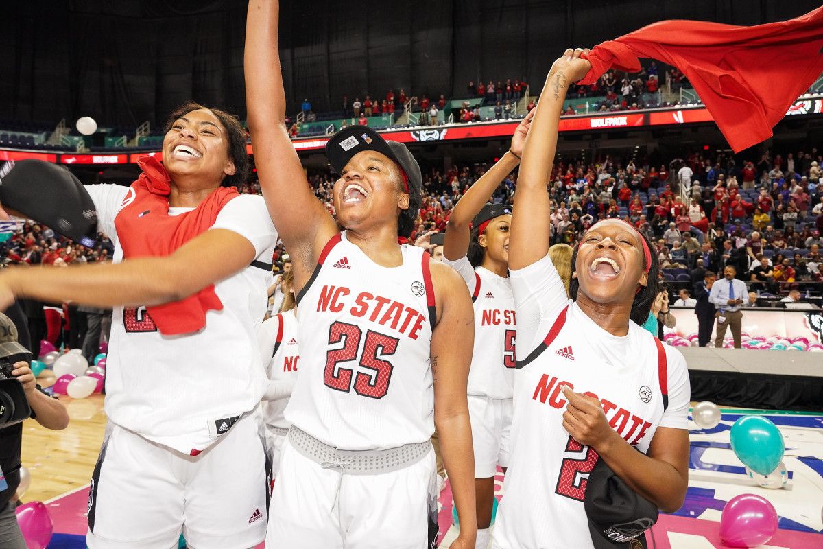 Erika Cassell, Kayla Jones and Grace Hunter salute the crowd after winning the ACC tournament championship