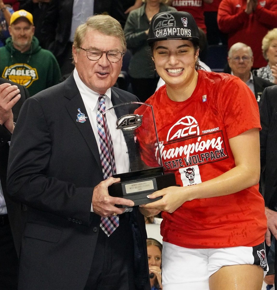 Senior Aislinn Konig accepts the tournament MVP trophy from ACC commissioner John Swofford