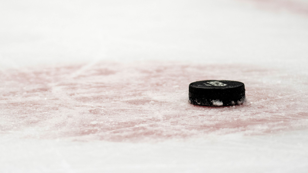 Closeup view of hockey puck laying on the ice