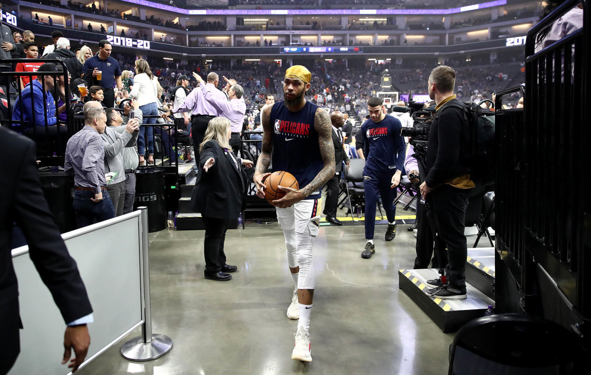 Brandon Ingram and Lonzo Ball leave the court after the New Orleans Pelicans vs. Sacramento Kings game is postponed.