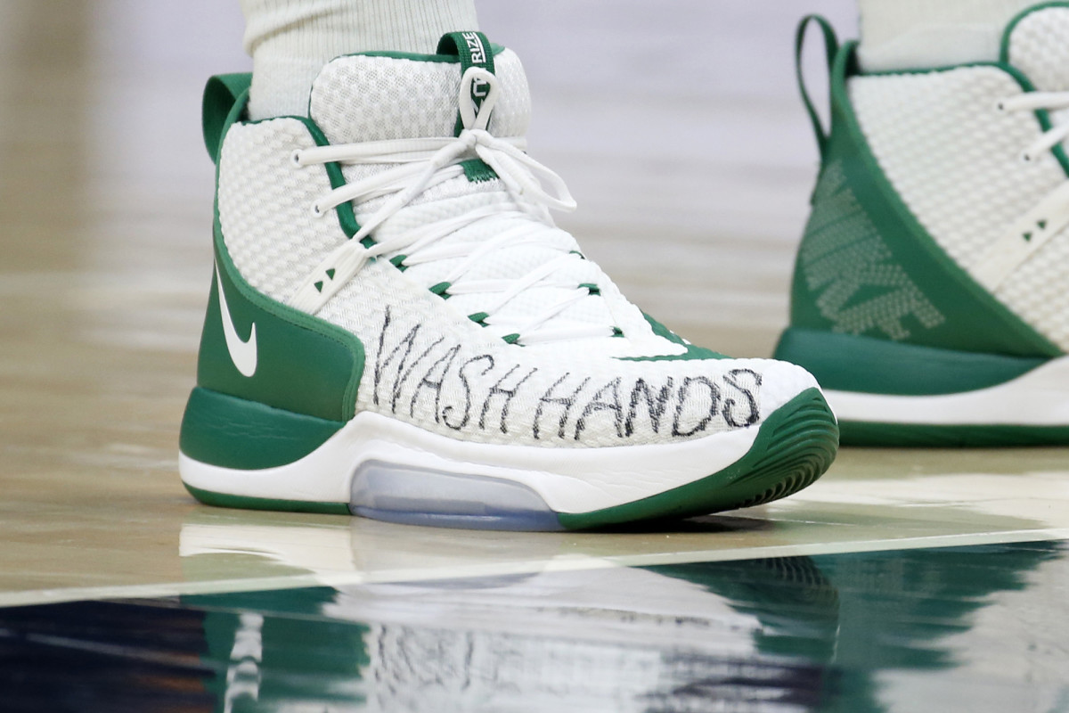 Boston Celtics center Enes Canter wears a message on his shoes for people to wash their hands.