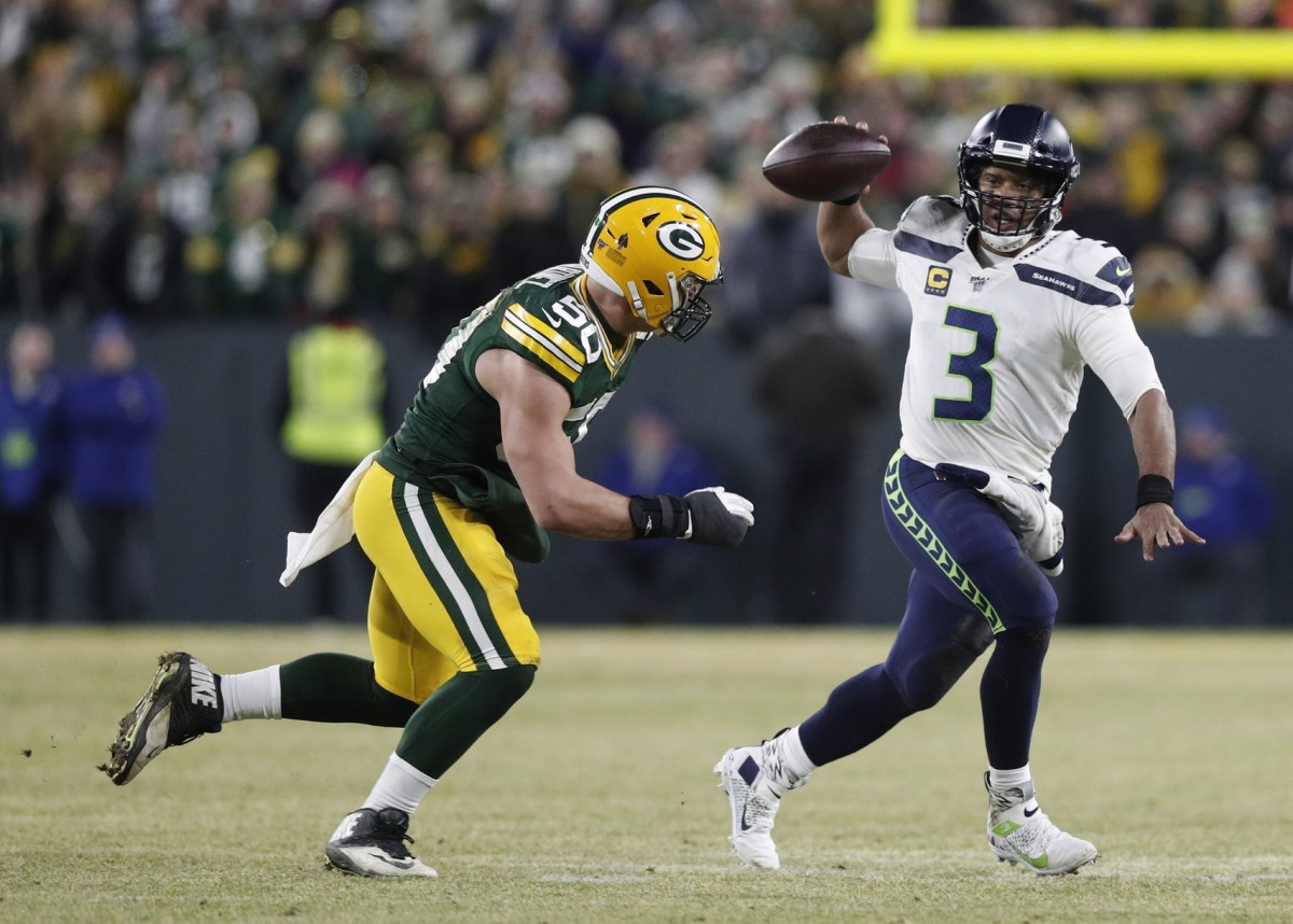 Jan 12, 2020; Green Bay, WI, USA; Seattle Seahawks quarterback Russell Wilson (3) is pressured by Green Bay Packers inside linebacker Blake Martinez (50) in the second quarter of a NFC Divisional Round playoff football game at Lambeau Field.
