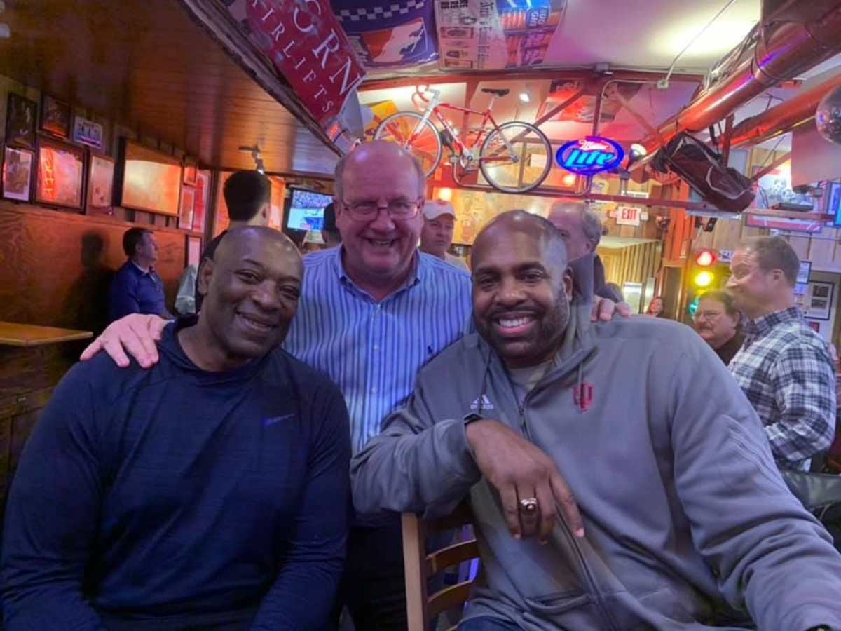 In town for Bob Knight's return to Assembly Hall in February, 1987 heroes Keith Smart (left) and Dean Garrett pose for a picture with Sports Illustrated Indiana's Tom Brew during dinner at Nick's English Hut.