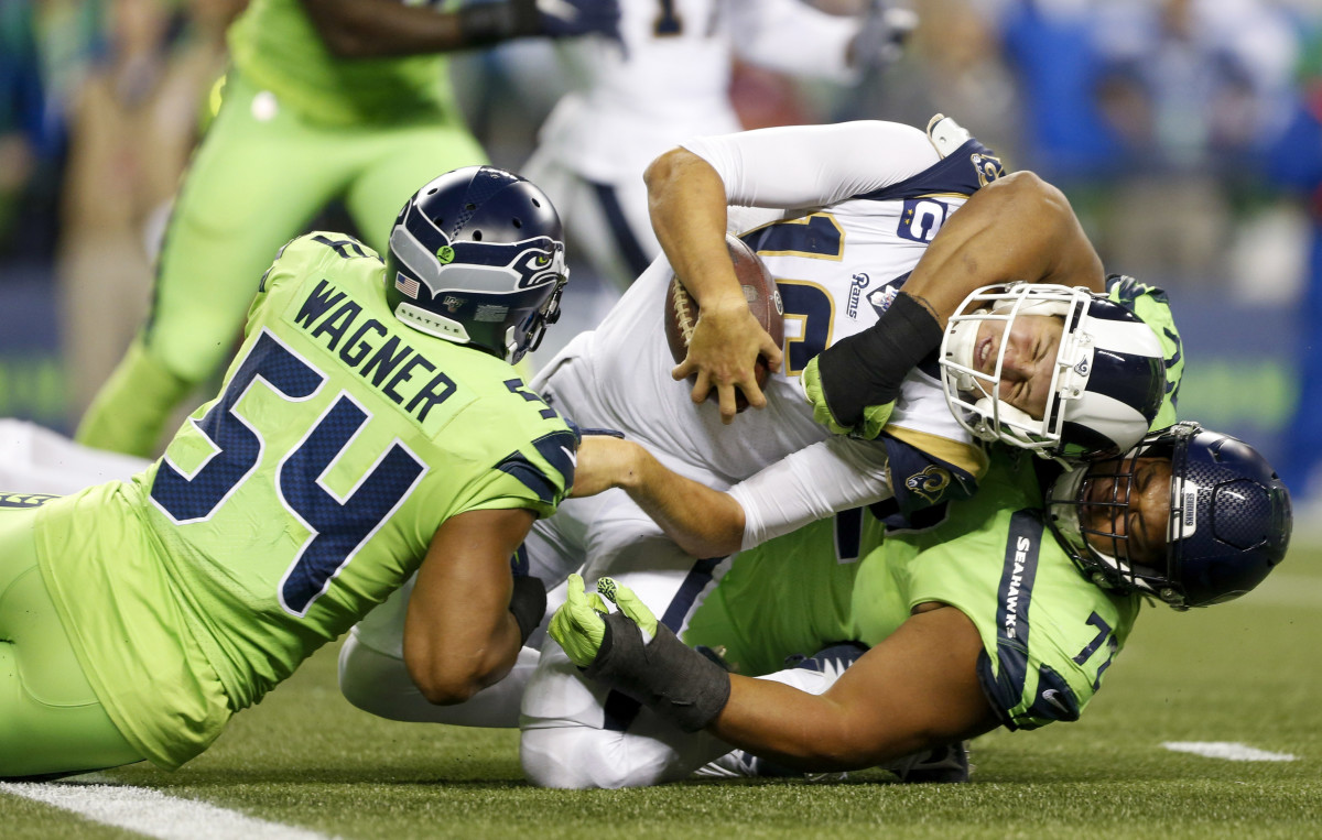 Seattle Seahawks middle linebacker Bobby Wagner (54) and defensive tackle Al Woods (72) stop Los Angeles Rams quarterback Jared Goff (16) short on a two-point conversion attempt during the third quarter at CenturyLink Field.