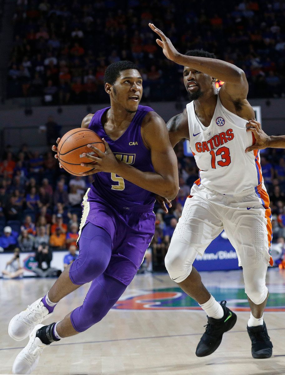 Darius Banks drives-in on Florida's Kevarrius Hayes.