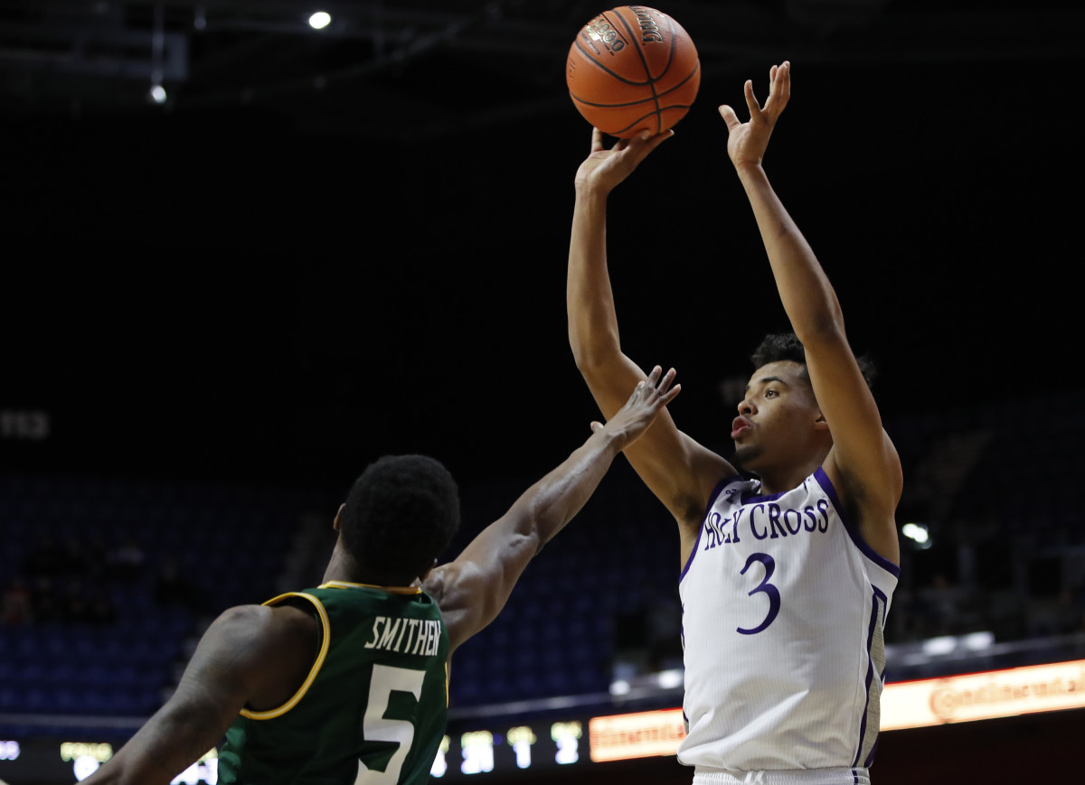 Holy Cross Crusaders guard Jacob Grandison (3) shoots against Siena Saints guard Kadeem Smithen (5) in the second half of this 2018 game at Mohegan Sun Arena. Holy Cross defeated Siena 57-45. Grandson sat out last season after transferring from Holy Cross to Illinois.