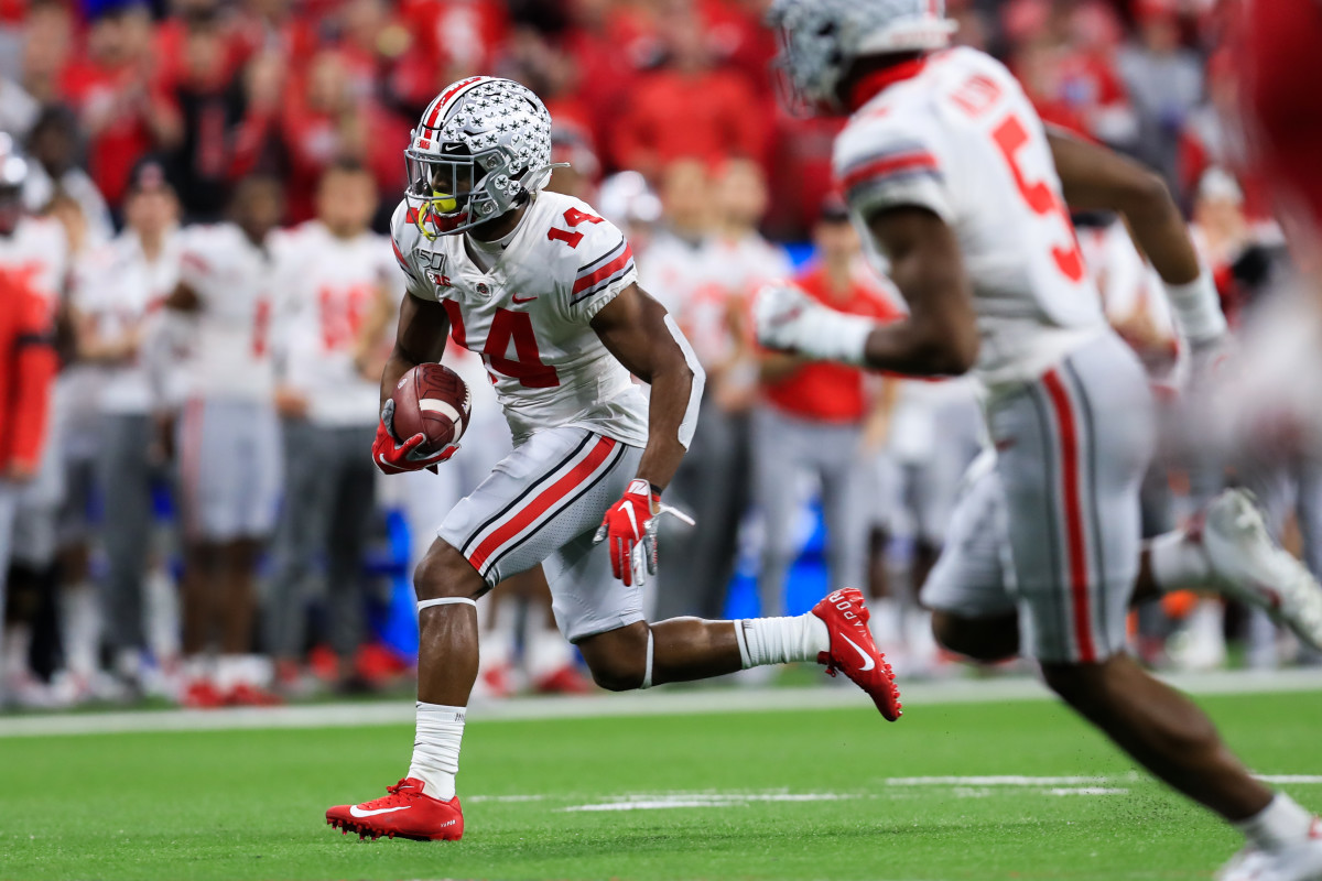 Dec 7, 2019; Indianapolis, IN, USA; Ohio State Buckeyes wide receiver K.J. Hill (14) carries the ball against the Wisconsin Badgers during the first half in the 2019 Big Ten Championship Game at Lucas Oil Stadium. Mandatory Credit: Aaron Doster-USA TODAY Sports