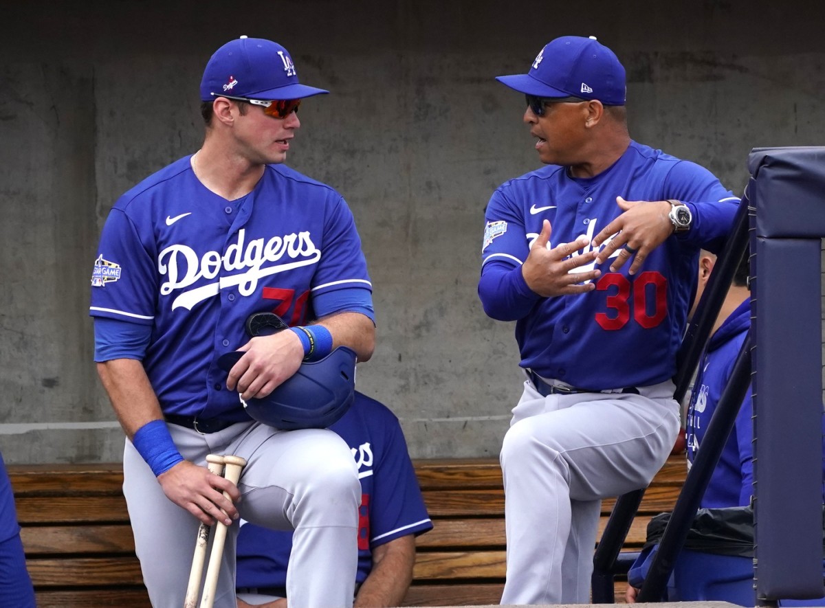Feb 28, 2020; Phoenix, Arizona, USA; Los Angeles Dodgers manager Dave Roberts (30) talks to DJ Peters (70) before a spring training game against the Milwaukee Brewers at American Family Fields of Phoenix. Mandatory Credit: Rick Scuteri-USA TODAY Sports