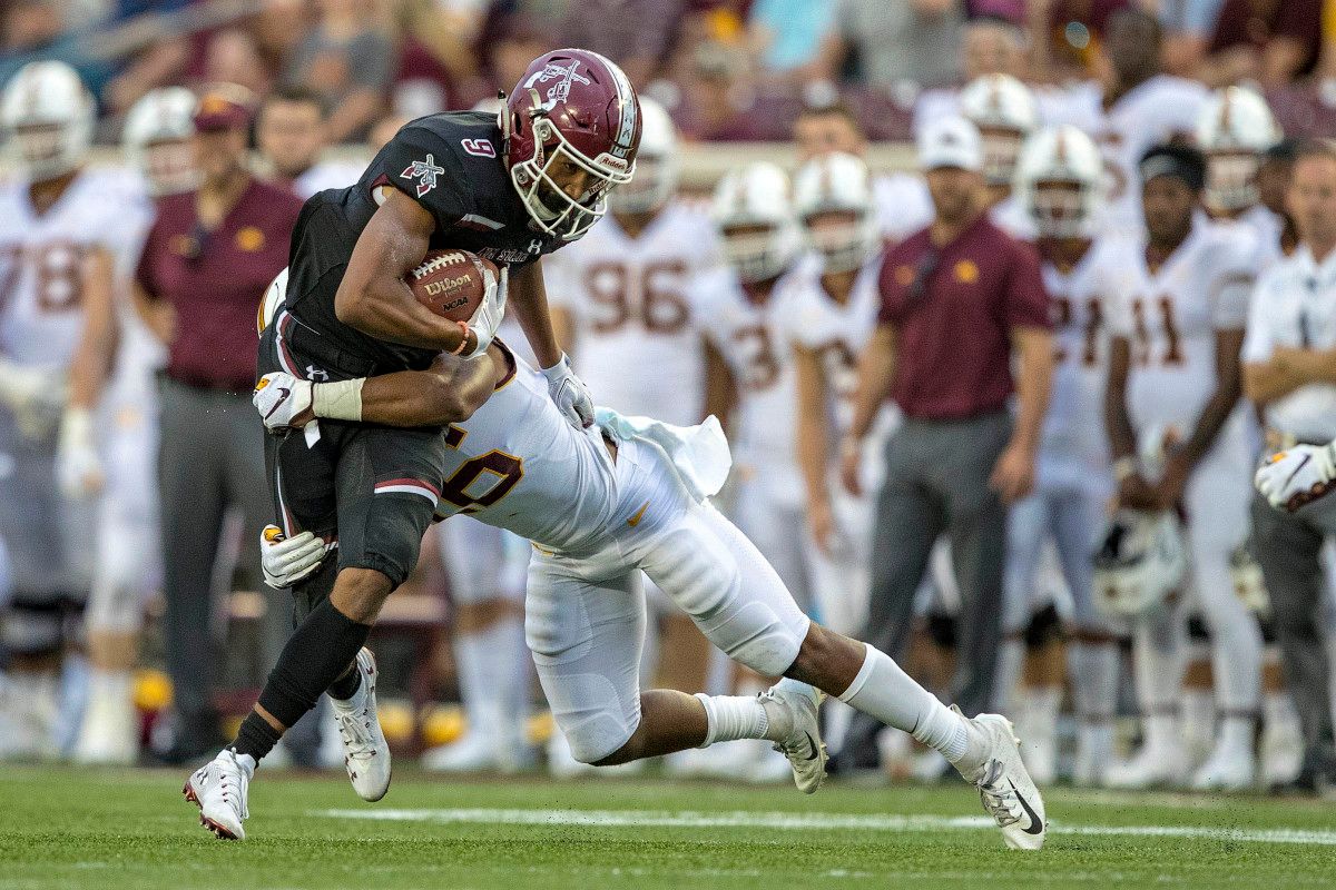New Mexico State Aggies wide receiver Drew Dan (9) gets tackled from Minnesota Golden Gophers defensive back Justus Harris (26) after making a catch in the first half at TCF Bank Stadium.