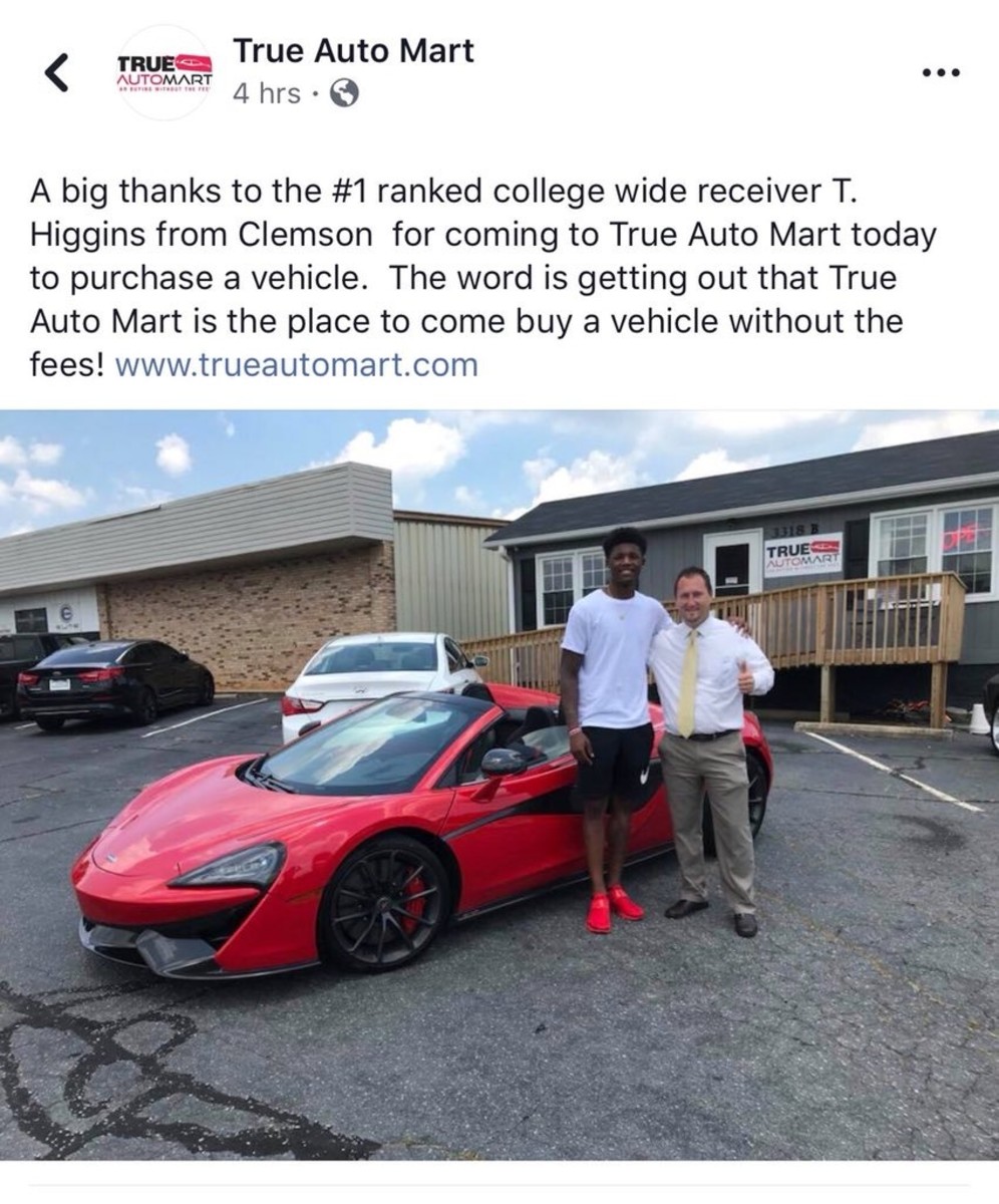 Photo of Clemson WR Higgins posing with 200K car deleted Visit NFL