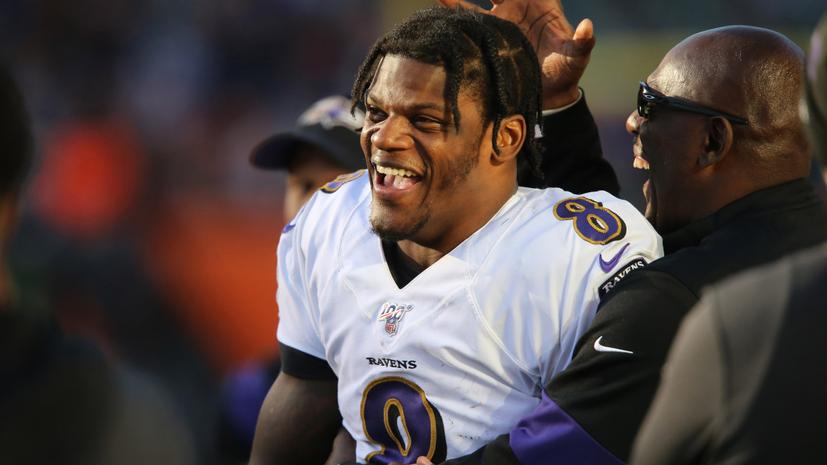 Lamar Jackson celebrates on the field during a Ravens game.
