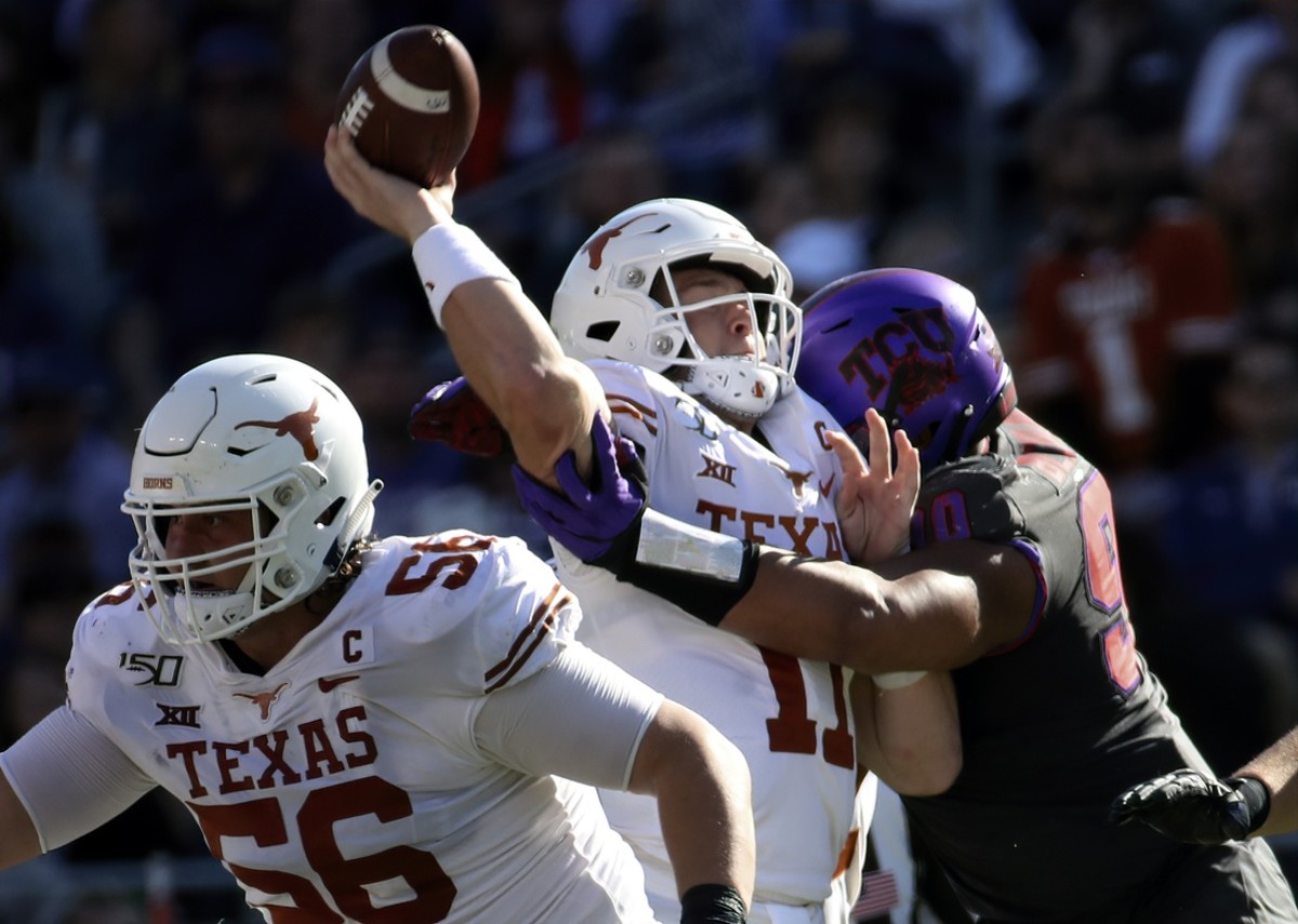 Oct 26, 2019; Fort Worth, TX, USA; Texas Longhorns quarterback Sam Ehlinger (11) is hit by TCU Horned Frogs defensive tackle Ross Blacklock (90) during the second quarter at Amon G. Carter Stadium. Mandatory Credit: Kevin Jairaj-USA TODAY Sports