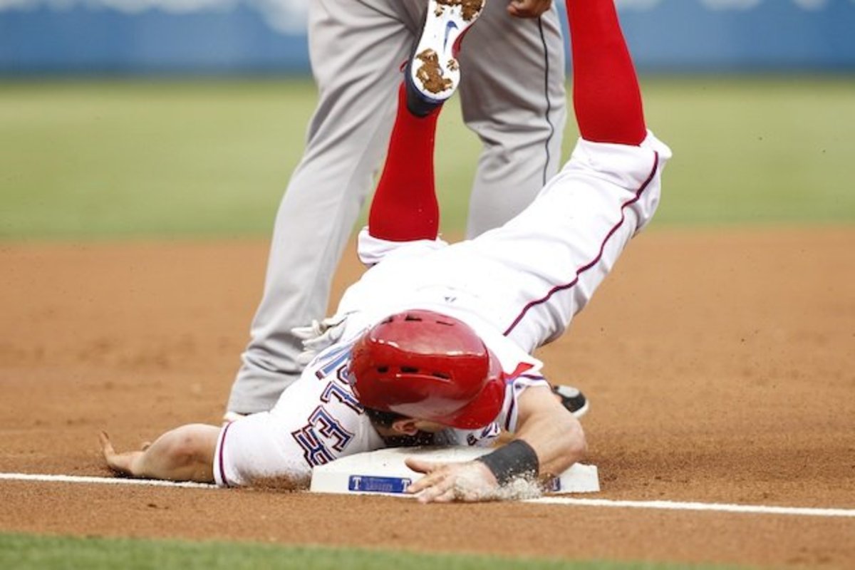Possibly qualifying athletic slide, Note position of fielder is improper.