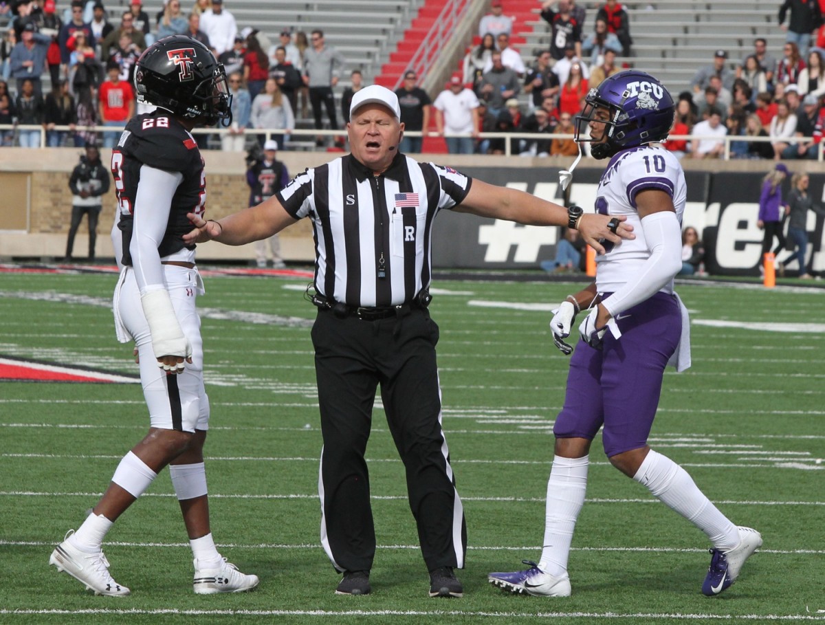 Defee has the biceps to hold players back as he did here between Texas Tech and TCU.