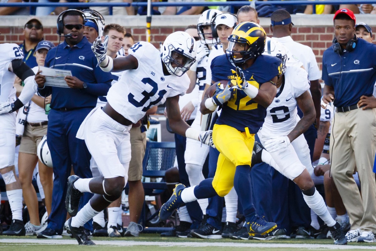 Sep 24, 2016; Ann Arbor, MI, USA; Michigan Wolverines running back Chris Evans (12) rushes past Penn State Nittany Lions linebacker Cameron Brown (31) in the second half at Michigan Stadium. Michigan 49-10.